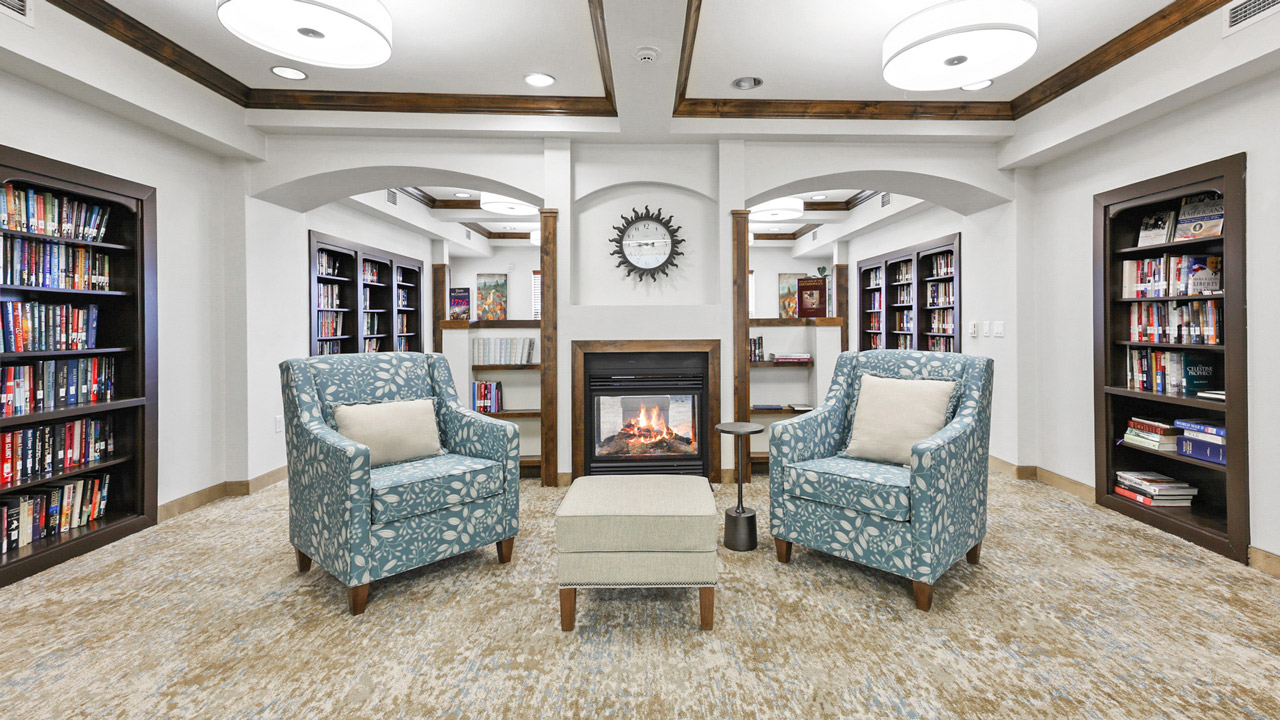 The library at Liberty Heights with shelves of books and comfortable seating