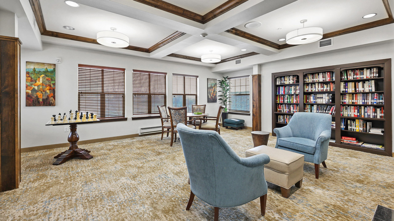 The library at Liberty Heights with shelves of books and comfortable seating