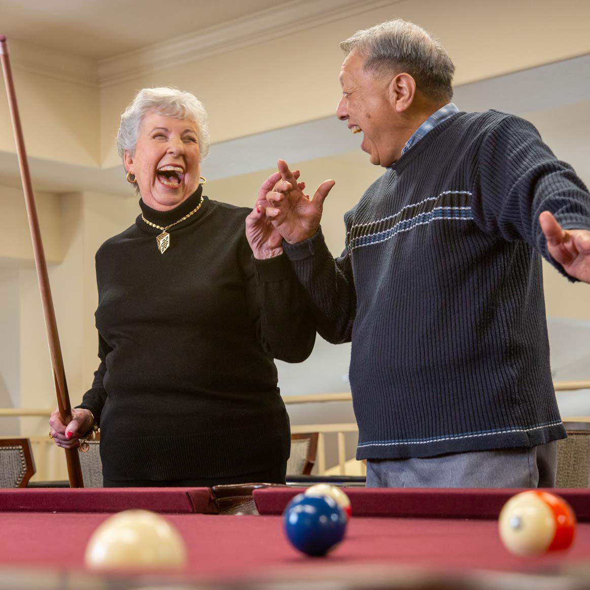 Residents playing billiards at Liberty Heights